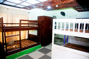 room with two double bunk bed and wardrobe