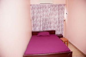 single room with pink colored walls